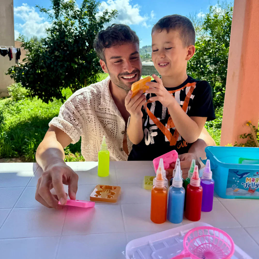 A child working independently at the kitchen table with the kit while a parent works nearby